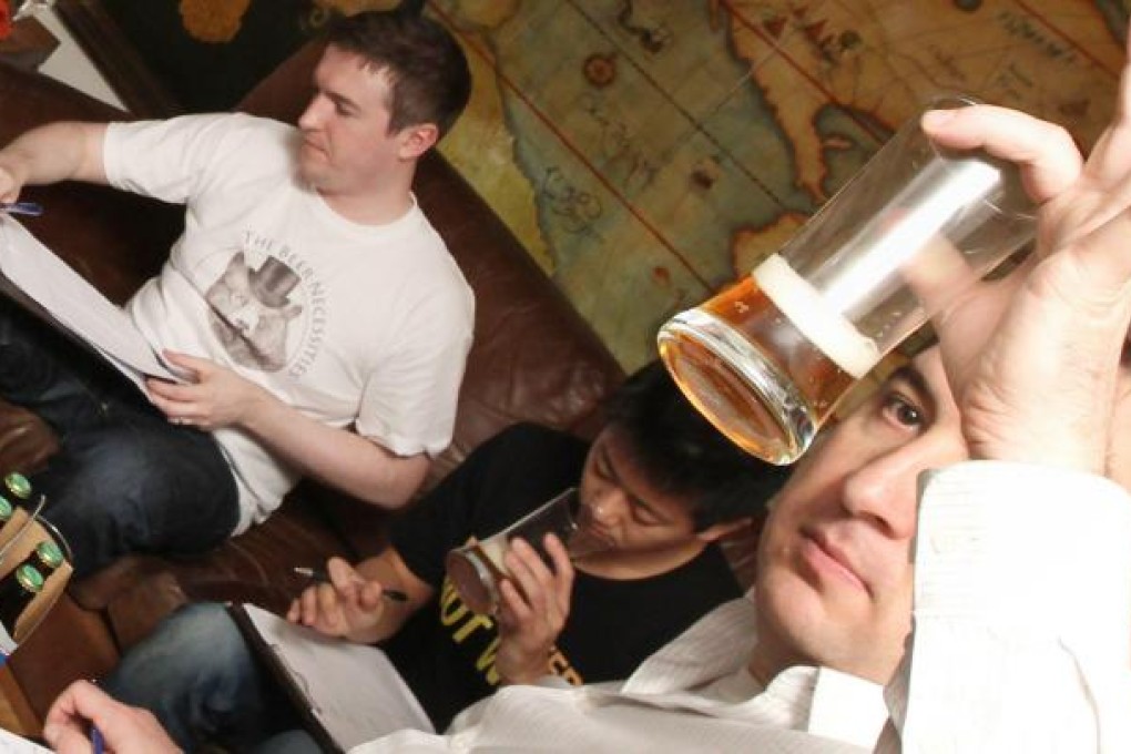 Judges (from left) Clark Hopton, Jonathan So and Jeff Boda taste some of the home-brewed ales on offer at The Globe. Photo: Edward Wong