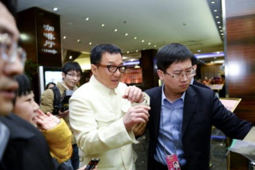 Jackie Chan arrives at the hotel served as an accommodation for the CPPCC members in Beijing. Photo: Xinhua
