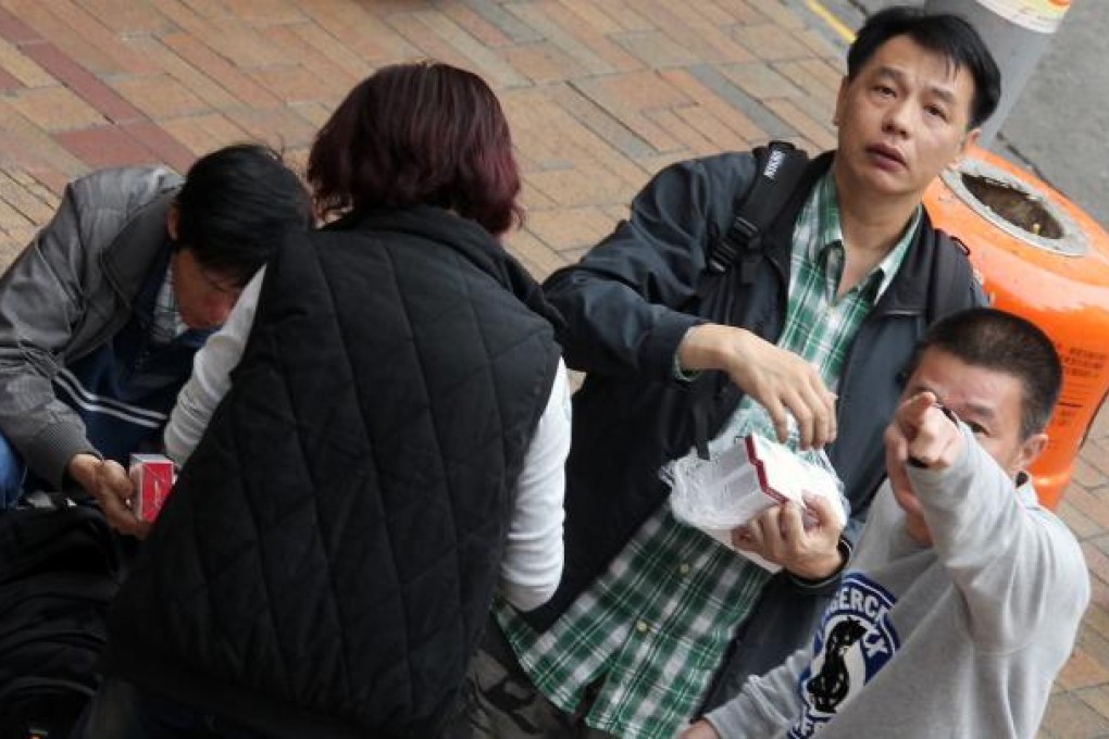Two men suspected to be parallel traders assault photographer May Tse after this picture is taken at Sheung Shui train station. Photo: May Tse