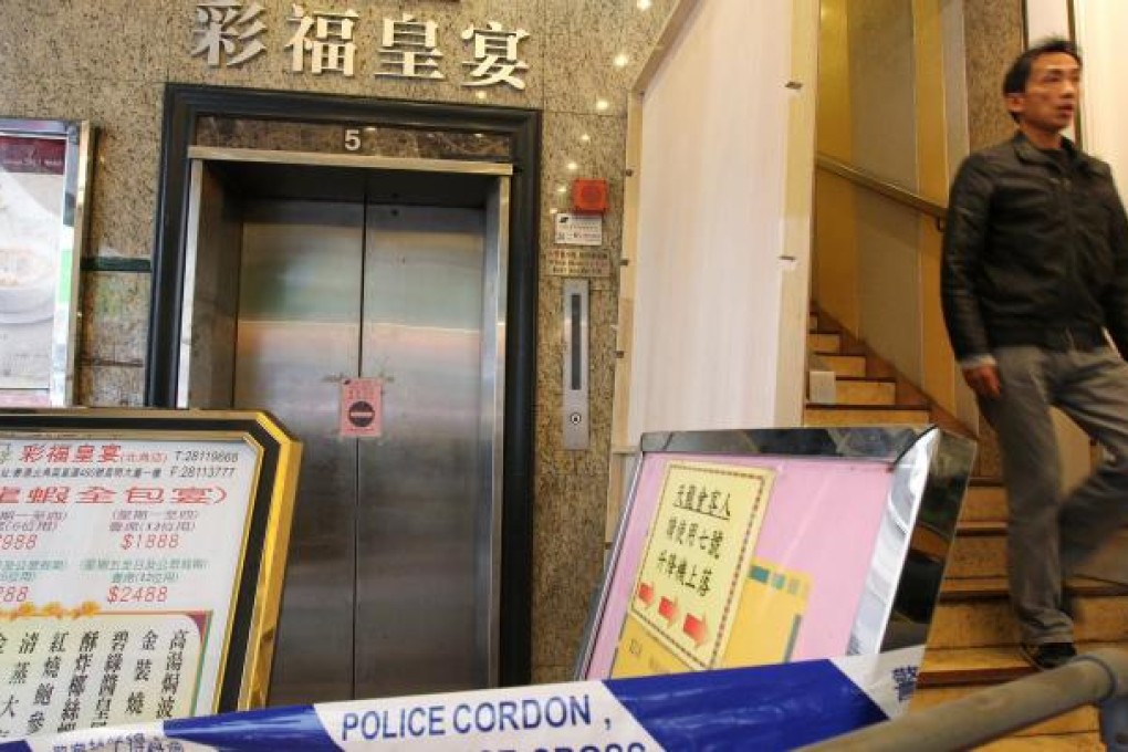 A worker blocks off the lift after the accident. Photo: Nora Tam