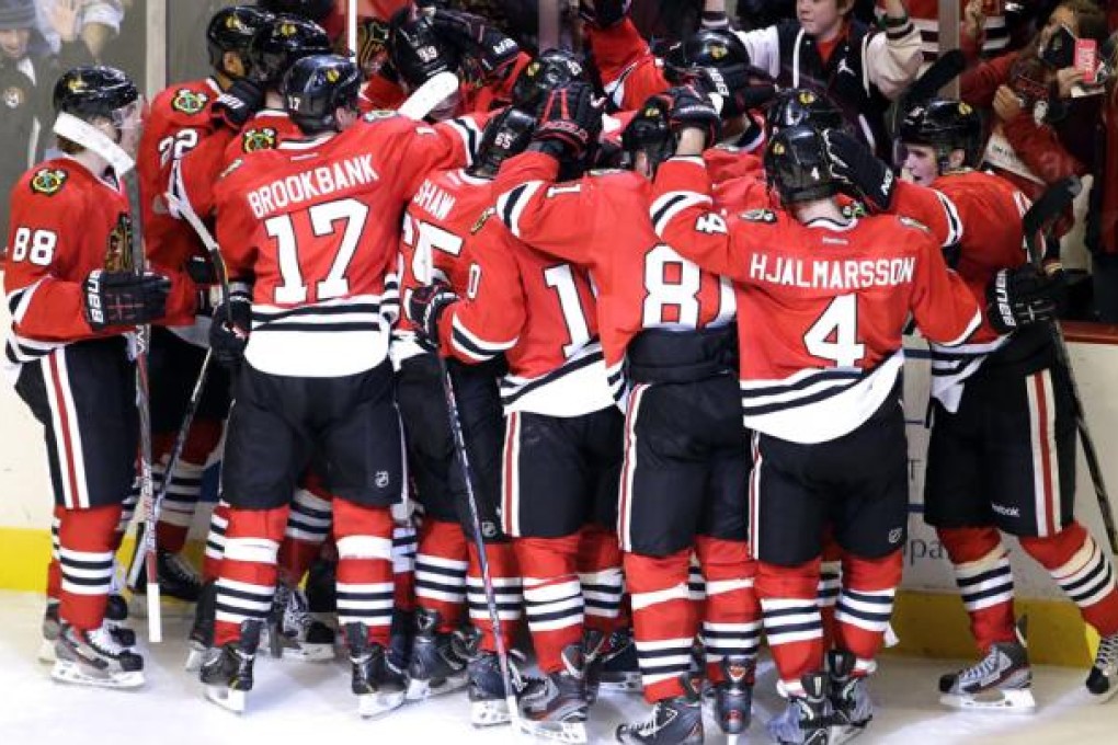 Chicago Blackhawks celebrate after winning an NHL hockey game against the Columbus Blue Jackets. Photo: AP