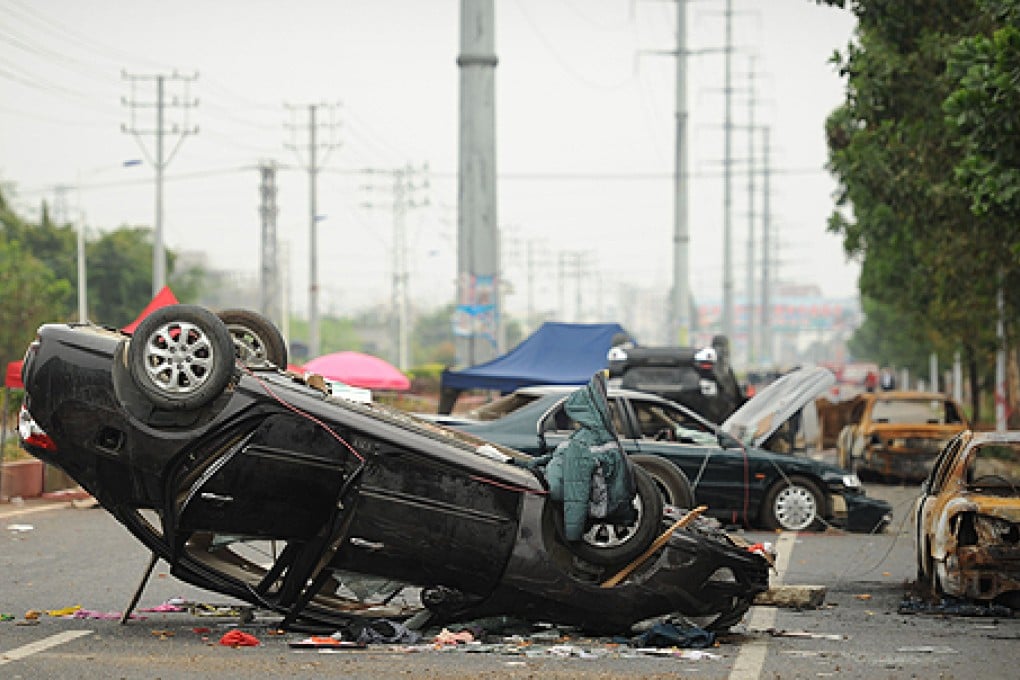 Overturned cars line a highway in Shangpu, Guangdong province, after a protest over a land deal. Photo: AFP