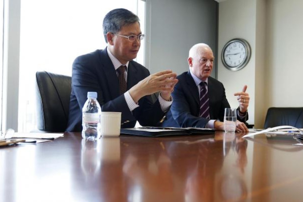 Li Fanrong of CNOOC and Nexen's Kevin Reinhart. Photo: Reuters