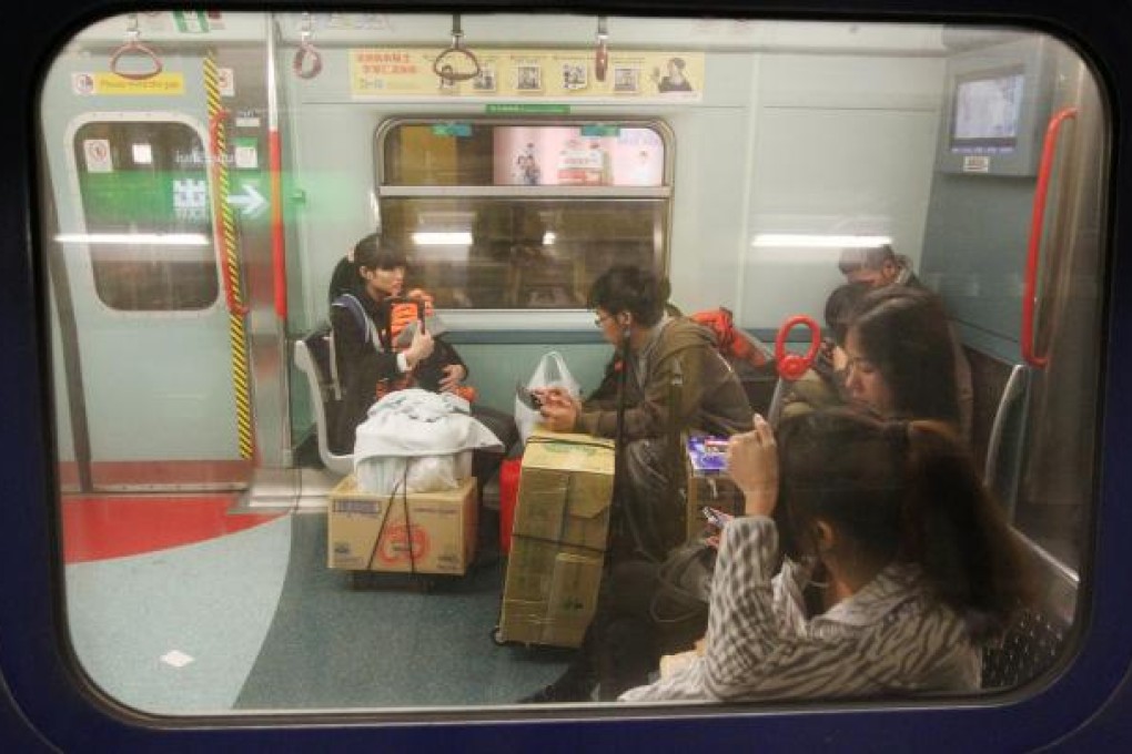 Travellers who ride the MTR with their packaged infant milk formula must now undergo security checks at Sheung Shui station to ensure they are not carrying too much of the product before they can board the train to the mainland. Photo: Felix Wong