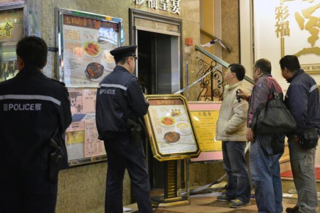 Several maintenance workers inspect the lift at King's Towers in North Point. Photo: Thomas Yau