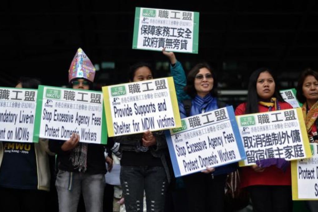 Domestic helpers gather to ask the government in Hong Kong to protect them from violence. Photo: AFP