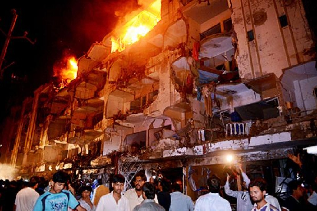A huge car bomb blew the front off two five-storey apartment blocks in the Abbas town area of Karachi. Photo: AFP