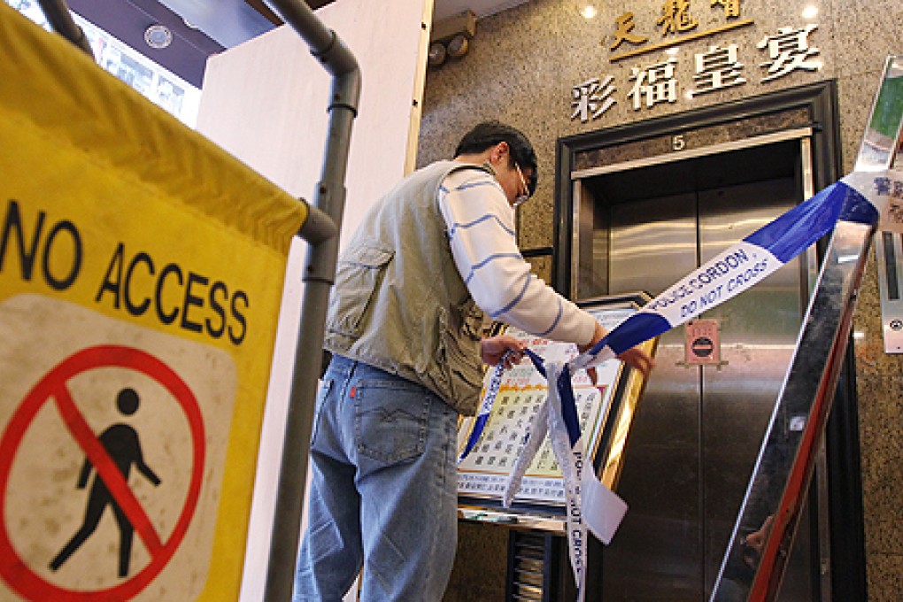 A worker blocks off the lift entrance at 480 King’s Road, North Point, after seven restaurant patrons were injured when the cables on the commercial building's lift broke. Photo: Nora Tam