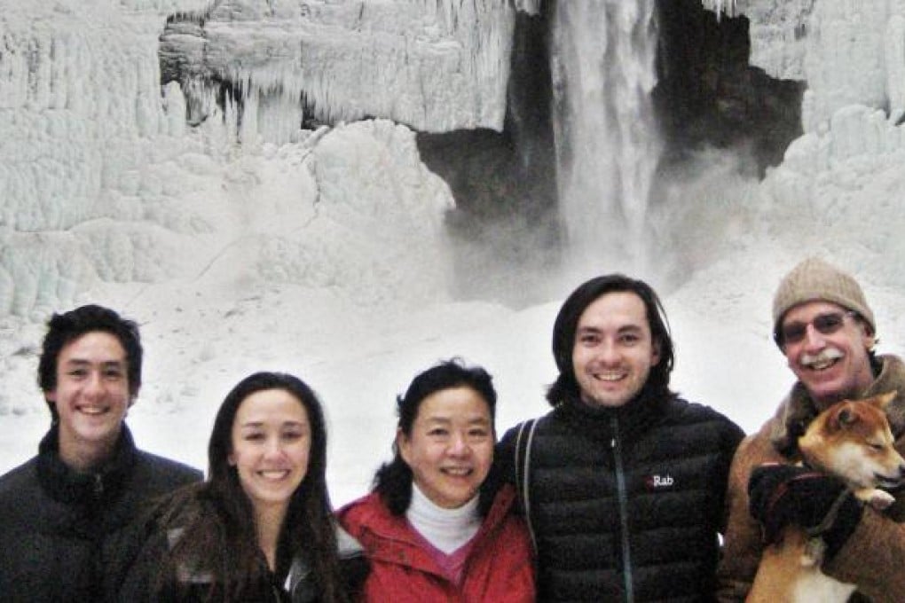 Writer Minfong Ho (in red) with her children (from left) Christopher, Mary and Danfung, and her husband John Dennis.