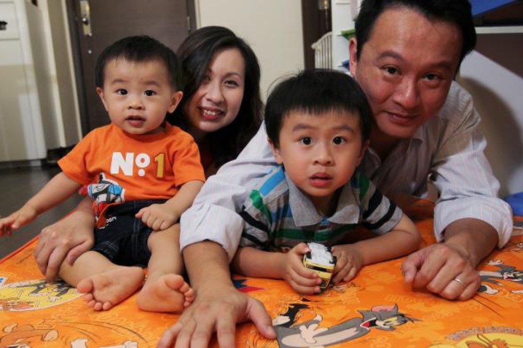 Happy father Ivan Wong and his wife, Shelley Lo, with their sons at home in Kowloon City. Thanks to new company policy, Ivan was able to enjoy paternity leave when they gave birth to their children. Photo: Edmond So