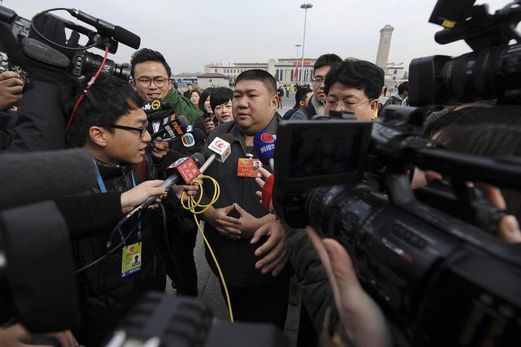 Mao Xinyu, grandson of late leader Chairman Mao, is surrounded as he arrives at the Great Hall of the People ahead of the Chinese People's Political Consultative Conference.