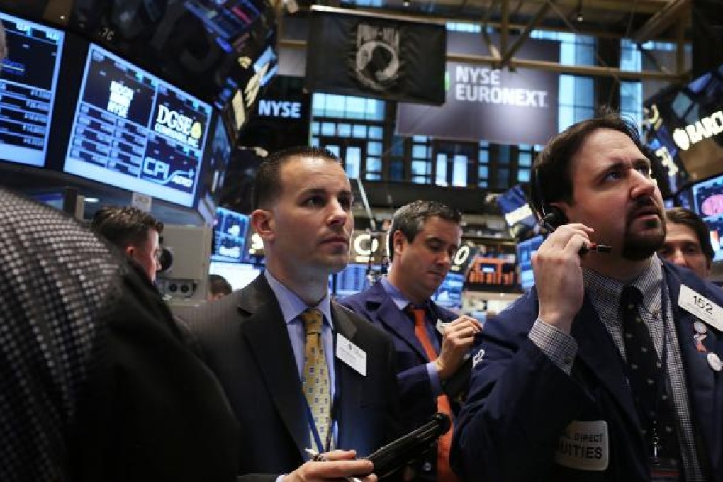 Traders work on the floor of The New York Stock Exchange. The Dow Jones Industrial Average rallied to a record high to close at 14,253.77 this week, and analysts say it hasn’t peaked yet. Photo: AFP