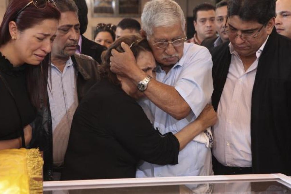 Bereaved parents Elena and Hugo delos Reyes Chavez (centre) lead a mass of mourners. Photo: Reuters