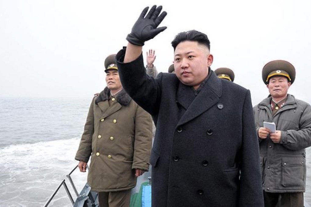North Korean leader Kim Jong-un waves from a boat during his visit to the Jangjae Islet Defence Detachment and Mu Islet Hero Defence Detachment on the front, near the border with South Korea. Photo: Reuters