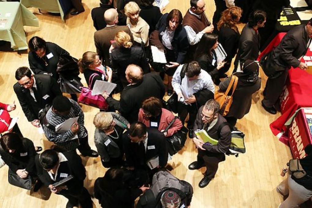 Job seekers speak to potential employers at a job fair in Manhattan. Photo: AFP