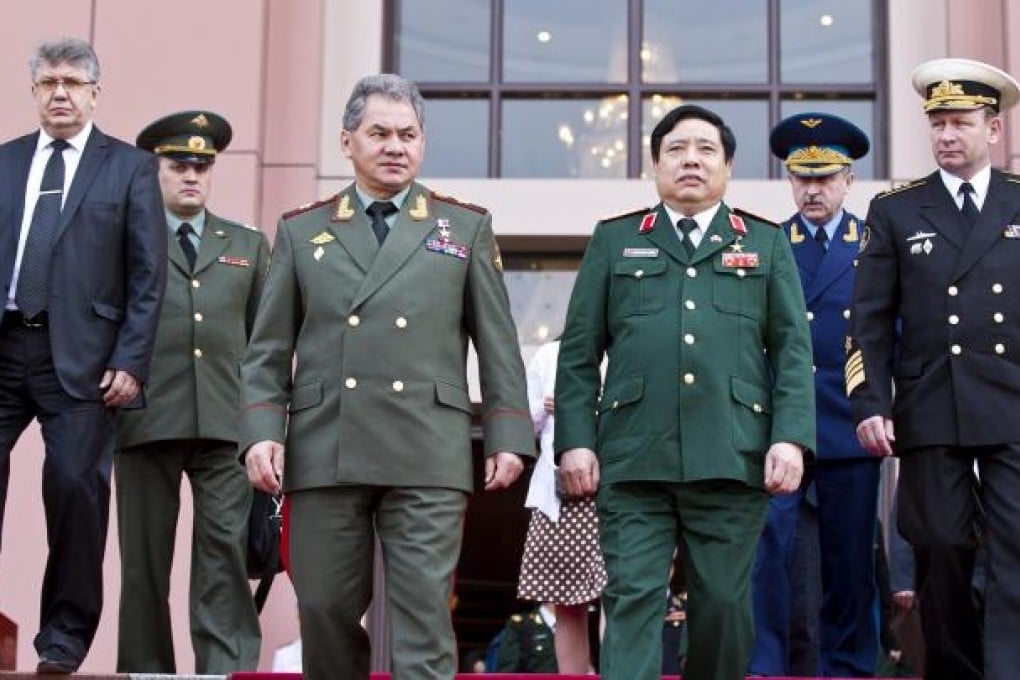 Hats off: Russian Defence Minister Sergei Shoigu, front left, stands beside Vietnamese counterpart Phung Quang Thanh. Photo: EPA