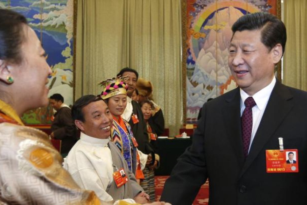 Xi Jinping greets a Tibetan NPC deputy yesterday. Photo: Xinhua
