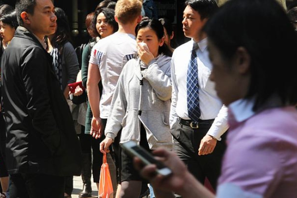 A pedestrian covers her face in Central amid severe air pollution levels. Photo: May Tse