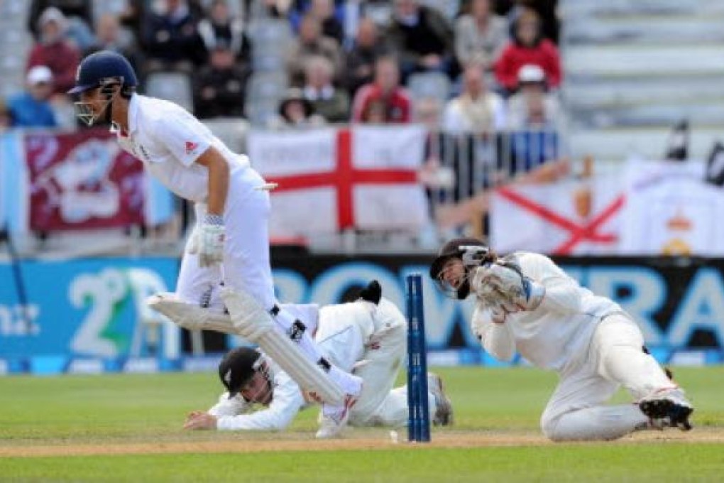 England's Alastair Cook makes his ground as the New Zealand wicket keeper B J Watling breaks the stumps on the fourth day of the 1st international cricket test at University Oval in Dunedin on Saturday. Photo: AP