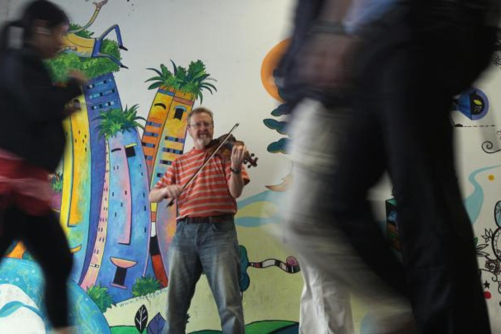 Dave May, a busker from Scotland, plays his fiddle at his familiar Central spot. He has been busking in Hong Kong for 17 years. Photo: K.Y. Cheng