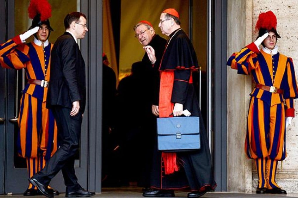 US cardinals Raymond Leo Burke and Roger Michael Mahony arrive for an afternoon meeting of pre-conclave on Friday at the Vatican. Photo: AFP