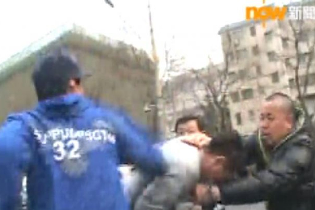 TV capture: TVB camera man injured by policemen near Liu Xia's home in Beijing.