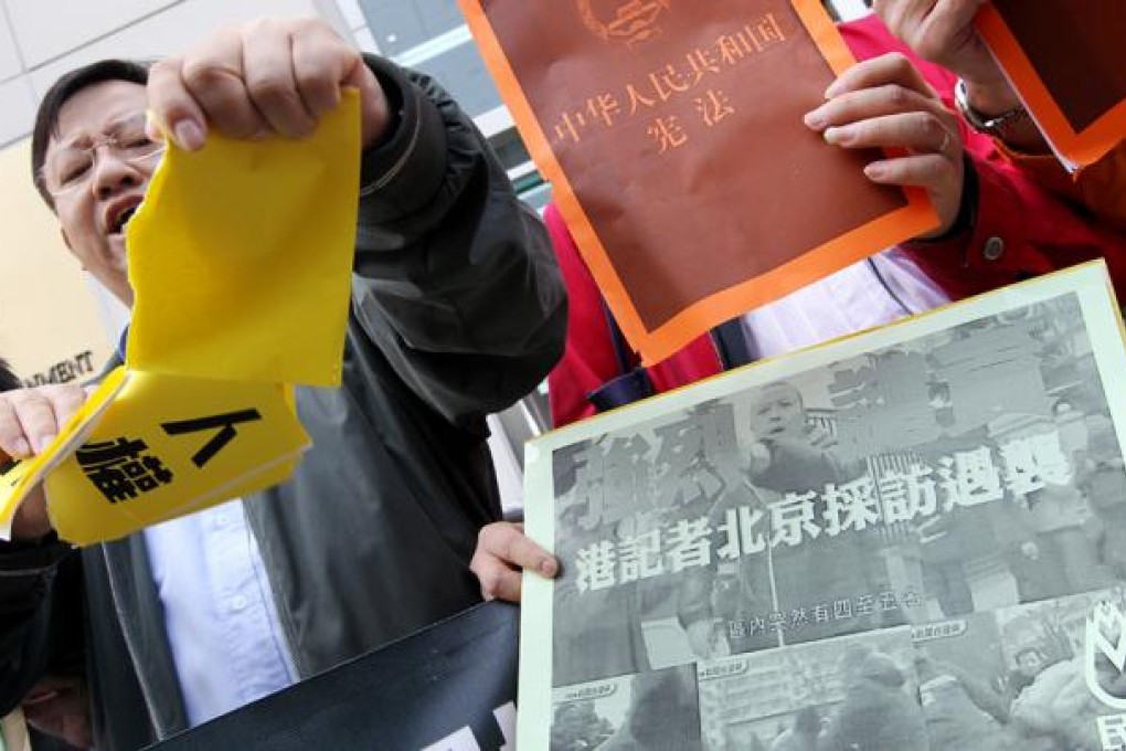 Protesters march to the central government''s liaison office in Hong Kong in protest at the attacks in Beijing. Photo: Felix Wong