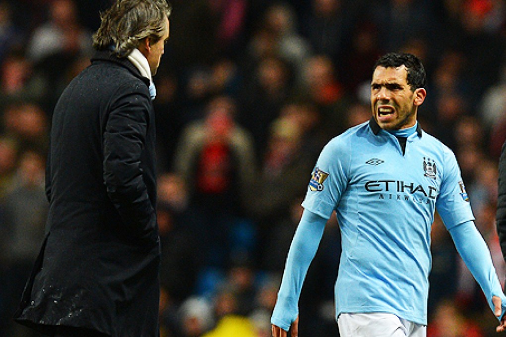 Carlos Tevez (right) and Manchester City manager Roberto Mancini. Photo: AFP