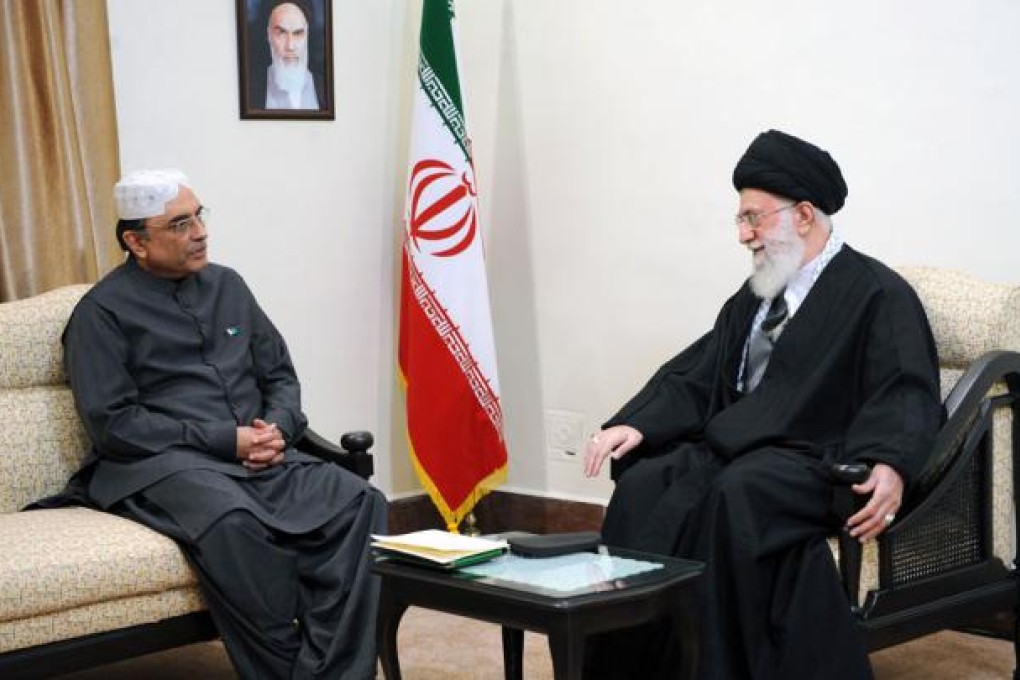 Iranian Supreme Leader Ayatollah Ali Khamenei talks with Pakistan's President Asif Ali Zardari during a meeting for the gas pipeline project. Photo: AFP