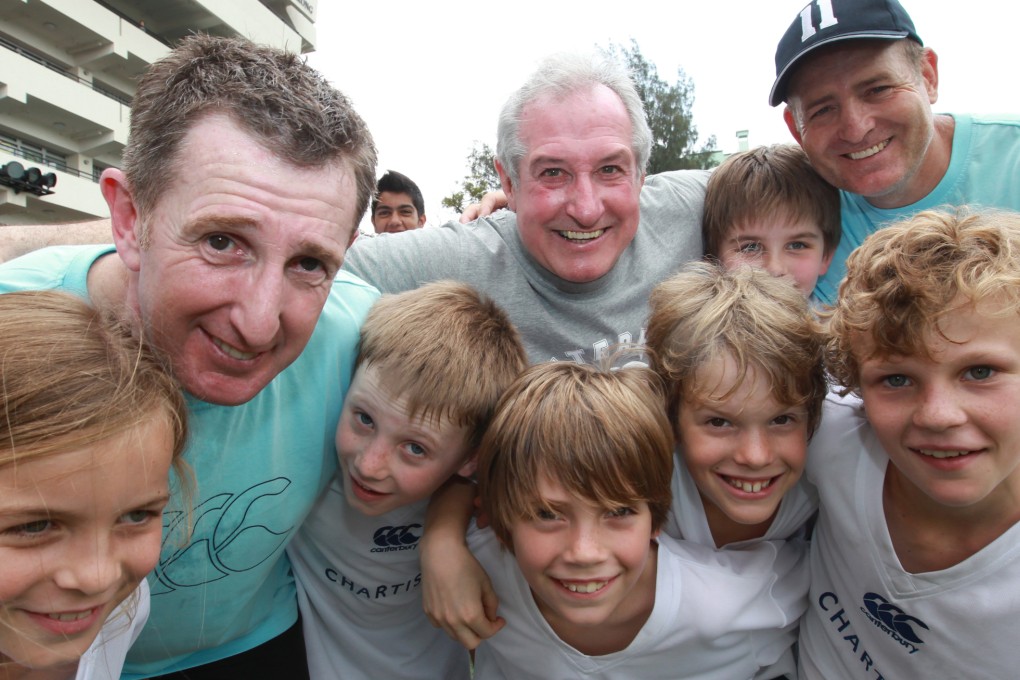 Rugby players are a different breed and the “gods of the game”, such as (left to right) Jonathan Davies, Gareth Edwards and David Campese, are always willing to give back, as these youngsters from Australian International School in Kowloon Tong found out during one Sevens week.  Photo: Felix Wong