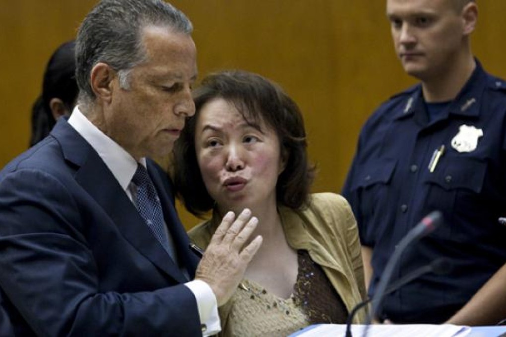Cecilia Chang, a former dean of New York's St John's University accused of fraud and embezzlement, talks to her lawyer during a court appearance. Photos: The New York Times
