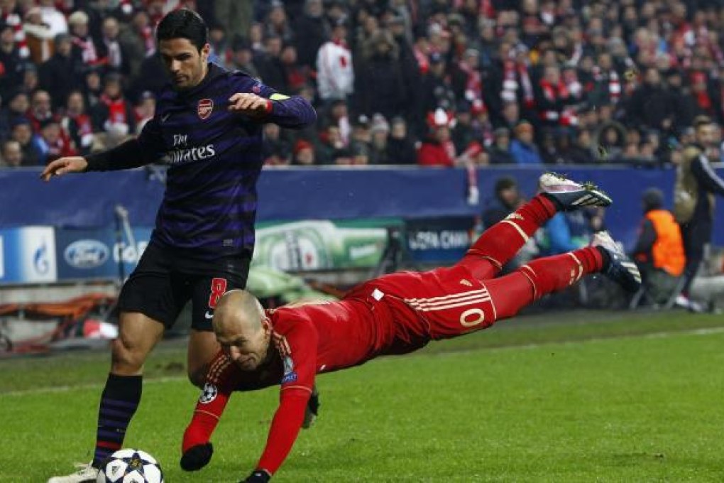 Bayern Munich's Arjen Robben goes flying as he tussles with Arsenal's Mikel Arteta during the Champions League clash in Munich. Photo: Reuters