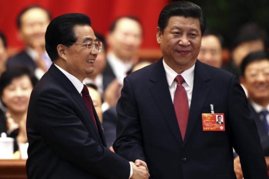 Hu Jintao (left) shakes hands with his successor as president Xi Jinping, also head of the Central Military Commission. Photo: Reuters