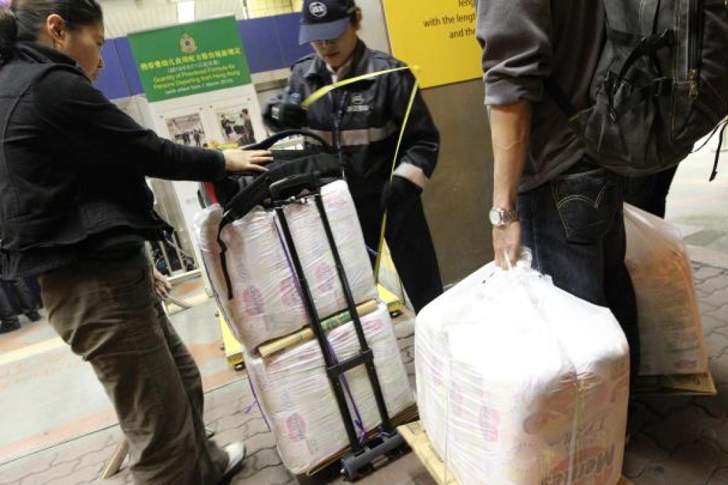 A security guard enforces the new baby formula limits at Sheung Shui in Hong Kong. Photo: SCMP