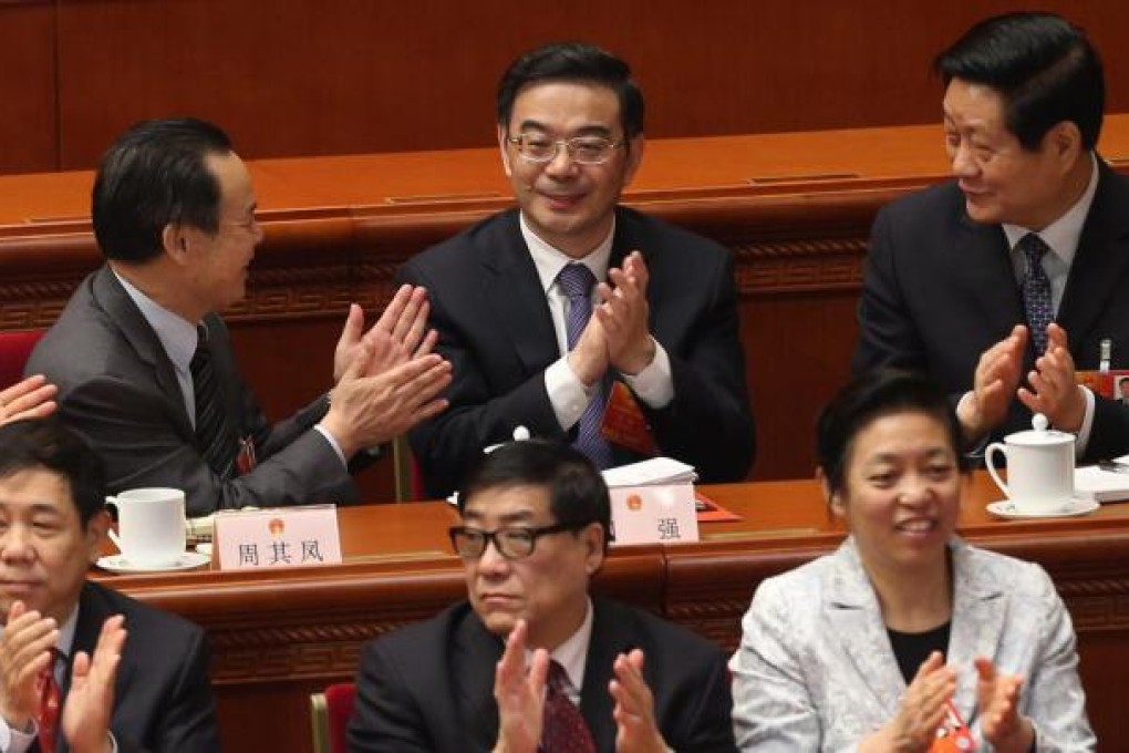 Zhou Qiang (centre, back row) is congratulated by other deputies after being elected president of the Supreme People's Court at the National People's Congress. Photo: Xinhua