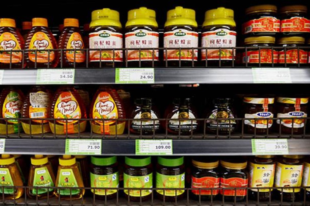 Genuine honey is displayed in a supermarket in Beijing. Chinese state media has quoted the China Bee Products Association as saying that half the honey sold in Chinese markets is fake and costs only one tenth of the price to produce. Photo: AFP