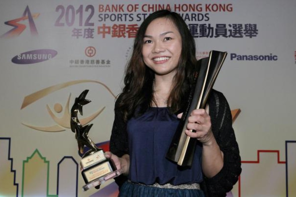 Lee Wai-sze shows off the two awards she won last night after a year in which she won an Olympic medal and a world title, among other successes. Photo: Edward Wong