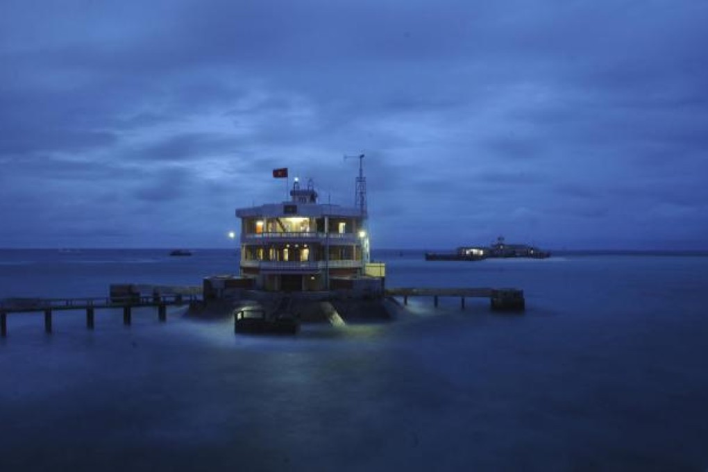 Vietnam's flag flies over the fortified Da Tay Island in the Spratlys archipelago. It is 25 years since China and Vietnam clashed over the islands, but the issue remains central to Beijing-Hanoi relations. Photo: Reuters