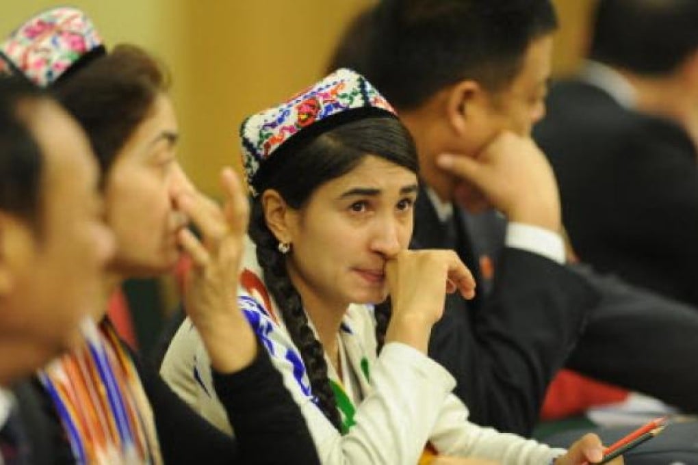 Rehangul Yimir (centre) attending a group meeting during the 12th National People's Congress at the Great Hall of the People in Beijing. Photo: AFP