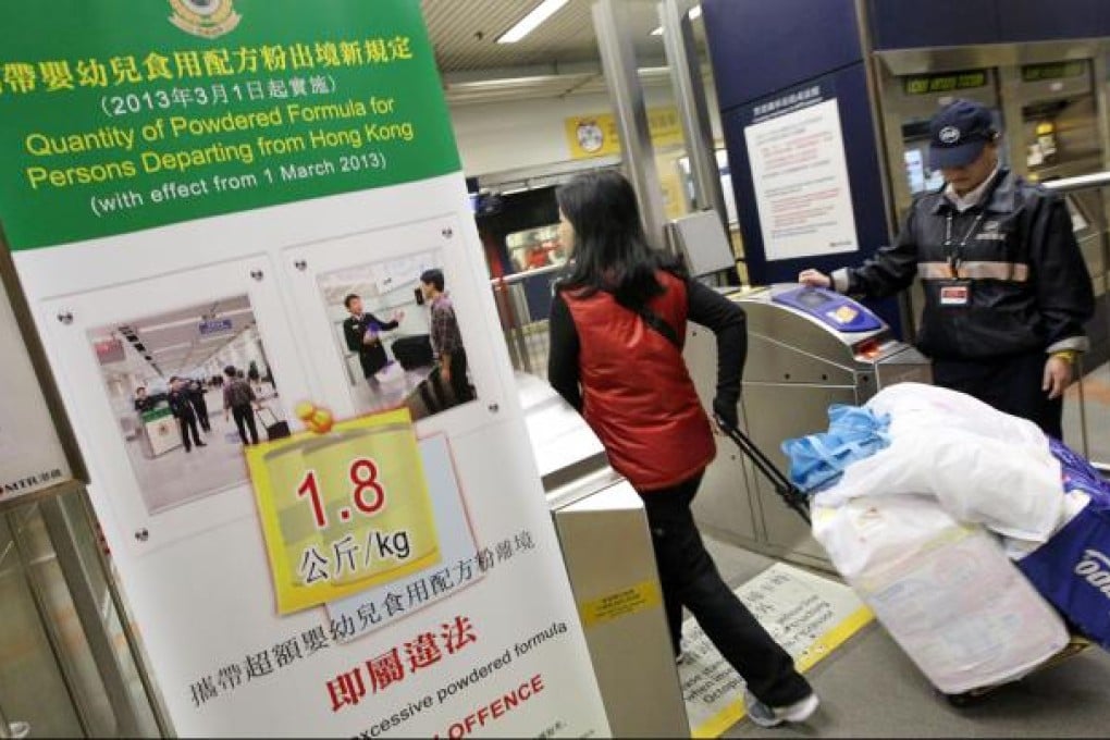 Travellers who ride the MTR with their packaged infant milk formula must now undergo security checks at Sheung Shui station to ensure they are not carrying too much of the product before they can board the train to the mainland. Photo: Felix Wong