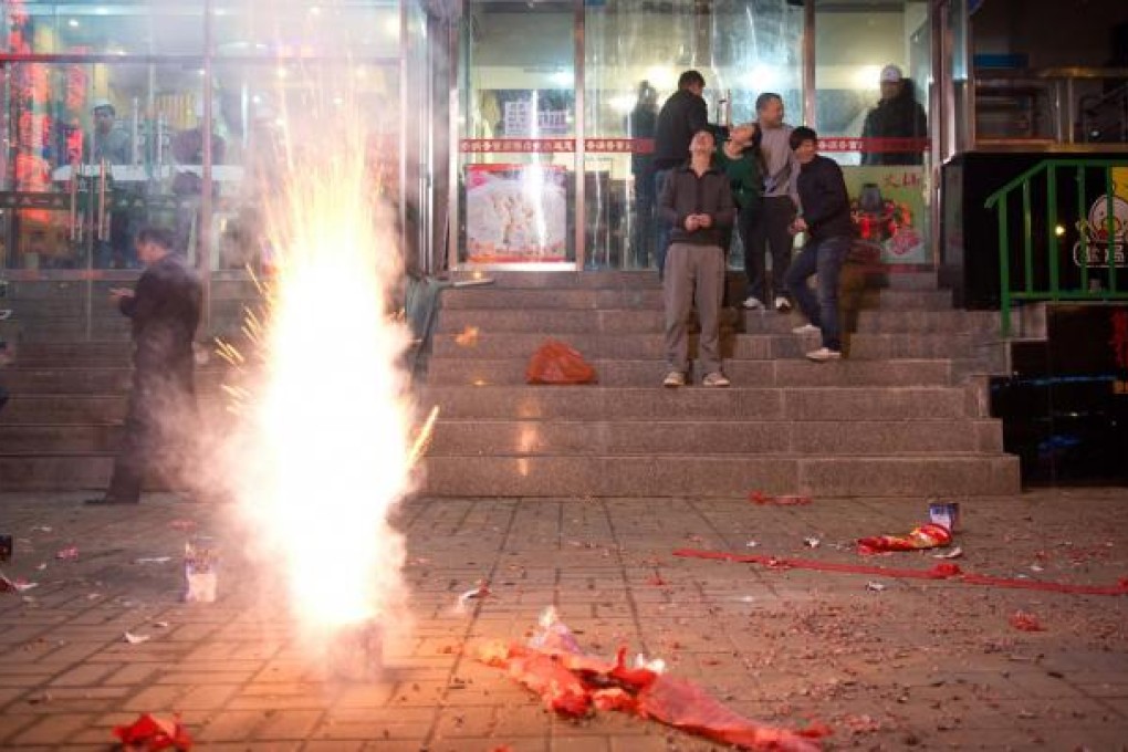 People watch fireworks in a Beijing street. Photo: AFP