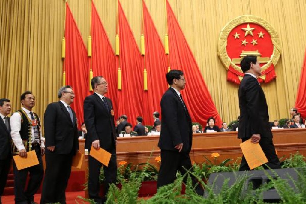 Deputies wait in line to cast their votes during the sixth plenary meeting of the first session of the 12th NPC. Photo: Xinhua