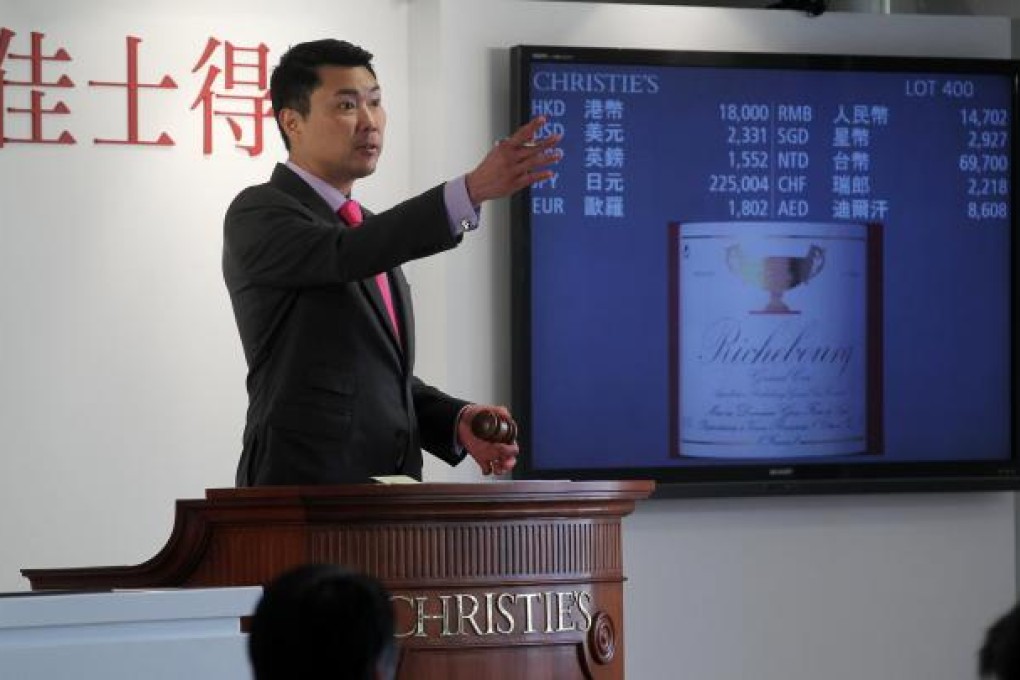 Simon Tam, head of wine for China at Christie's, conducts the auction of Henry Tang's 810-lot collection. Photo: K.Y. Cheng