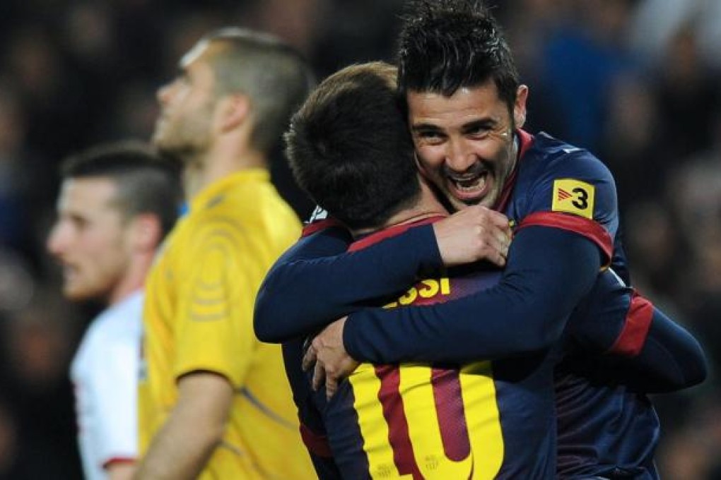 Barcelona's David Villa (right) celebrates with teammate Lionel Messi after scoring against Rayo Vallecano at the Camp Nou. Photo: AFP