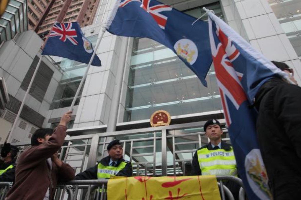 Protesters display Hong Kong colonial flags outside the central government's liaison office on January 1. Photo: SCMP Pictures