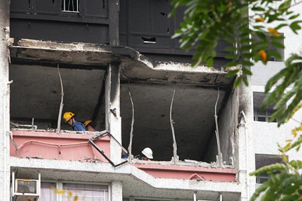 Firemen investigate the cause of the blaze that badly damaged the 10th-floor flat of Tak Yue House at Hau Tak Estate in Tseung Kwan O. Photo: David Wong