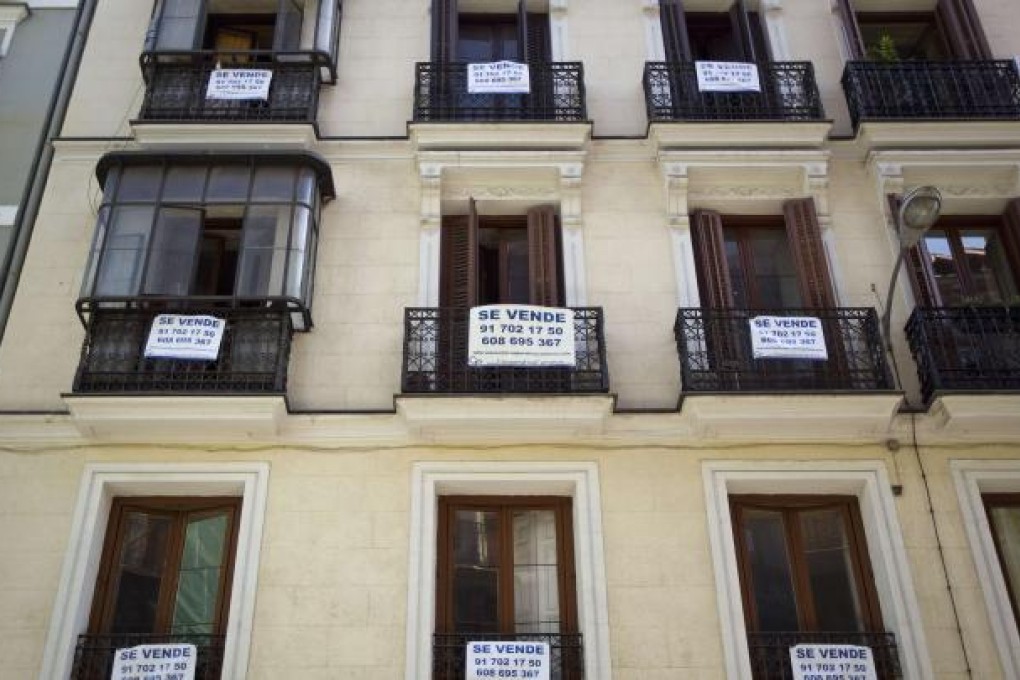 For Sale signs hang on apartment balconies in Madrid. Deep-pocketed Russians are offering a glimmer of hope to Spain’s battered property sector, snapping up luxury villas. Photo: Reuters