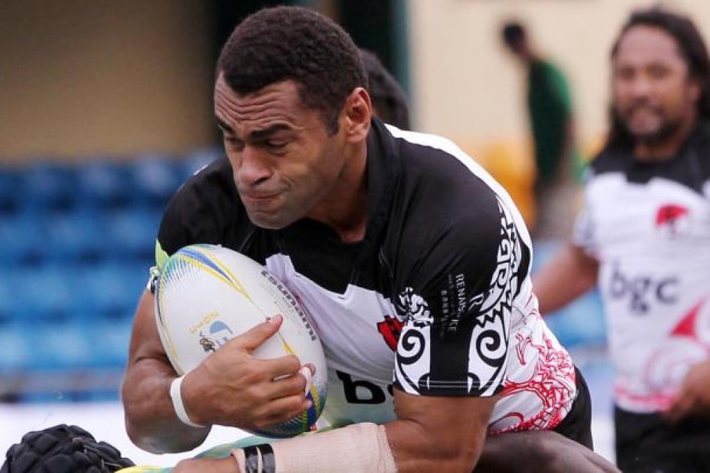 BGC APB All Stars' Matakai Ravulo charges through Rwanda's Philippe Mana during their GFI HKFC Tens clash. Photo: KY Cheng