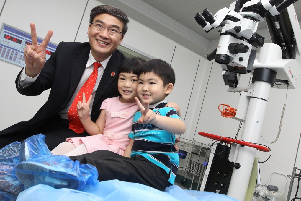 Dr Dennis Lam with his children Alyssa and Brian in an operation room at his eye hospital in Shenzhen. Photo: Edward Wong