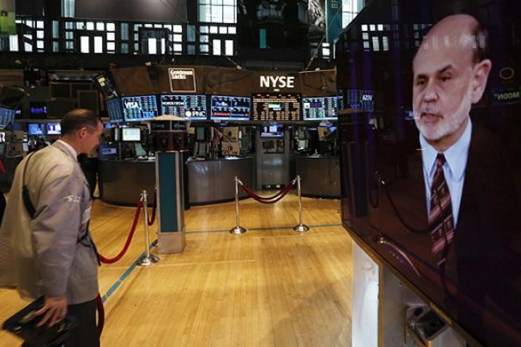 A press conference by Federal Reserve Chairman Ben Bernanke is broadcast on the floor of the New York Stock Exchange. Photo: Reuters